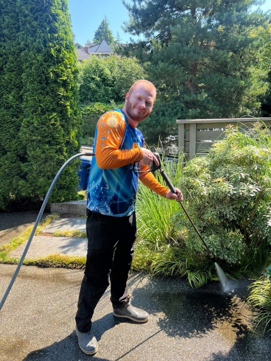 Dylan Thornsberry, Seattle ProWash owner, treating a property with a pump sprayer