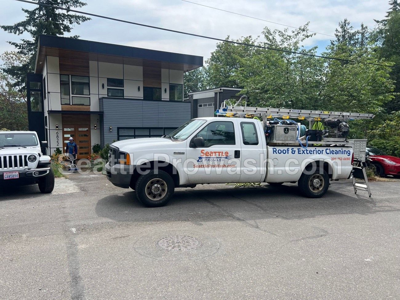 Seattle ProWash lettered service truck with ladder at a residential job site