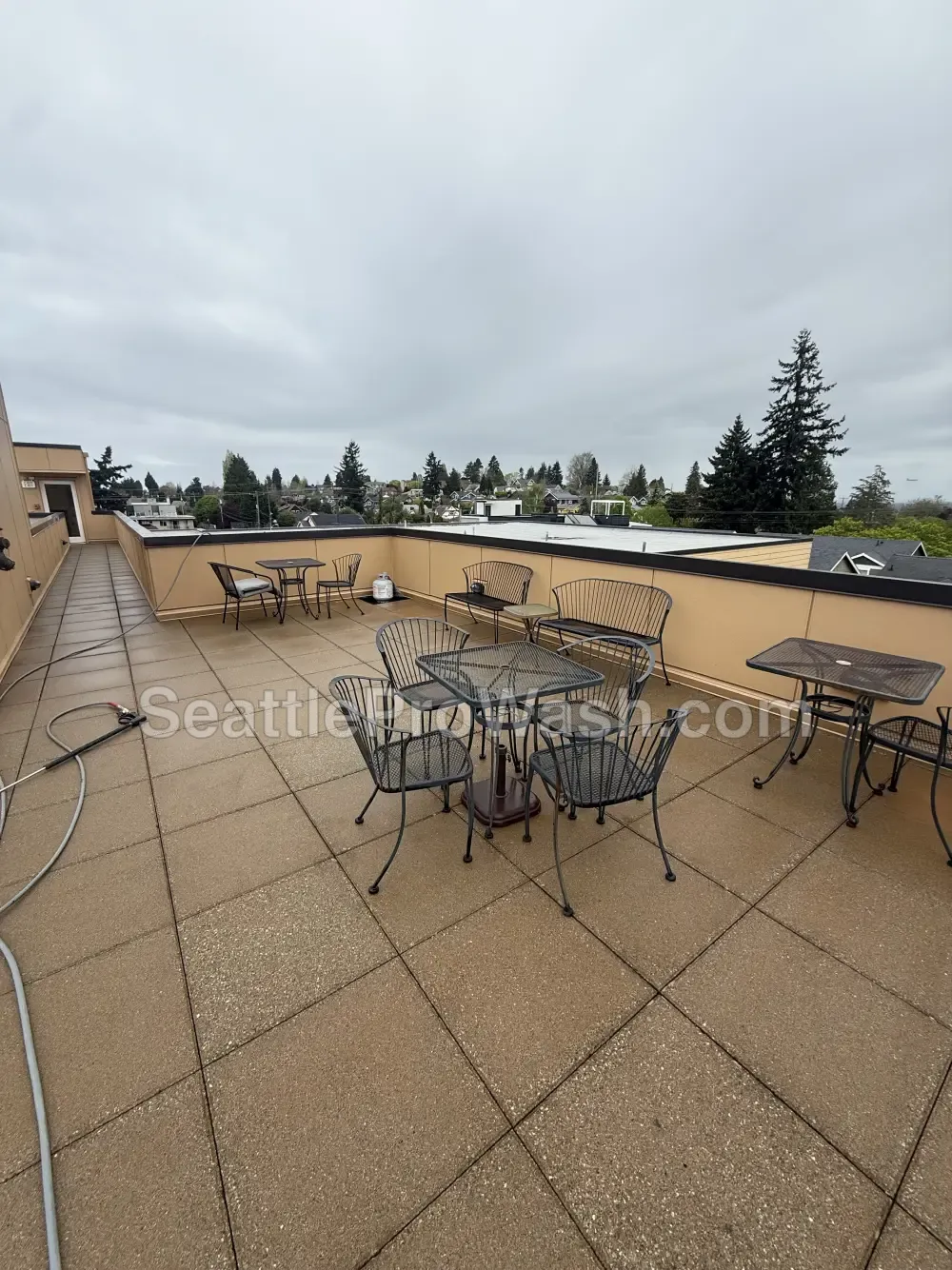 Rooftop patio pressure washing before and after in the Seattle area after cleaning