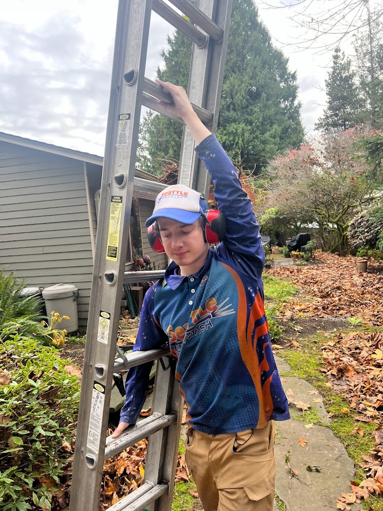 Technician moving ladder for roof access